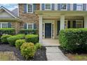 Home's stone facade and manicured landscaping add to its curb appeal at 6027 Windfall Ct, Powder Springs, GA 30127