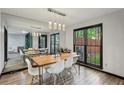 Stylish dining room with modern lighting, large windows, and seating for six at 2908 Woodruff Se Dr, Smyrna, GA 30080