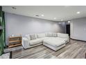 Cozy living room featuring a large sectional sofa and hardwood floors at 2908 Woodruff Se Dr, Smyrna, GA 30080