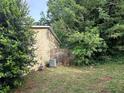 Backyard featuring the side of the home, partial fencing, surrounded by lush greenery and mature trees at 2940 Caller Ct, Marietta, GA 30060