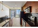 Modern kitchen with stainless steel appliances and black tile backsplash at 361 17Th Nw St # 2607, Atlanta, GA 30363