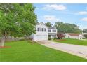 Beautiful two-story house with manicured lawn, driveway, a two-car garage and mature trees at 1194 Grandview Cir, Powder Springs, GA 30127
