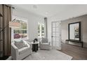 Bright sitting room featuring neutral decor, hardwood floors, and large windows at 1640 Tide Mill Rd, Cumming, GA 30040