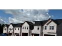 Row of new townhomes under construction with black roofs and light siding, near Seward St and Dawson St intersection at 218 Seward St # 92, Conyers, GA 30094