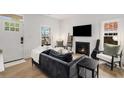 Cozy living room featuring natural light, a contemporary fireplace, and modern furnishings at 212 Haralson Ne Ave, Atlanta, GA 30307