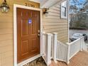 Brown front door featuring the house number 2190, exterior lighting, and a white handrail at 2190 River Heights Se Ct, Marietta, GA 30067