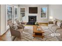 Staged living room featuring a fireplace, hardwood floors, and double doors to the outside at 2190 River Heights Se Ct, Marietta, GA 30067