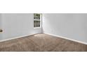 Clean and well-lit bedroom with plush carpet and a window at 3534 Oakshire Se Way, Atlanta, GA 30354