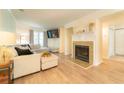 Bright living room featuring hardwood floors, a cozy fireplace, and ample natural light at 3677 Blackshear Ct, Duluth, GA 30096