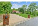 Brick pillars flank the long driveway leading up to this gorgeous home situated on a large private lot at 1275 Fontainebleau Ct, Lawrenceville, GA 30043