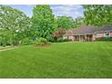 Beautiful front yard boasts a lush green lawn and mature trees adding to the home's curb appeal at 1275 Fontainebleau Ct, Lawrenceville, GA 30043