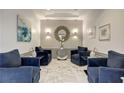 Modern lobby with blue armchairs, marble floors, and accent lighting at 2870 Pharr Court South Nw # 2404, Atlanta, GA 30305