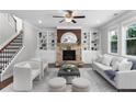Inviting living room with stone fireplace, custom built-ins, and plush seating, great for Gathering gatherings at 333 Gardens Of Harmony Dr, Canton, GA 30115