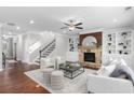 Spacious living room featuring a stone fireplace, custom built-ins, and modern furniture, perfect for entertaining at 333 Gardens Of Harmony Dr, Canton, GA 30115