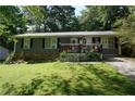 Classic one-story house with a welcoming porch and a beautifully maintained front lawn at 377 Black Oak Ct, Lawrenceville, GA 30046