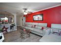 Inviting living room featuring a stylish sofa, a glass table and a vibrant accent wall at 377 Black Oak Ct, Lawrenceville, GA 30046