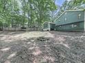 Large backyard, perfect for outdoor activities and entertaining, offering privacy and space for relaxation at 215 Little Brook Ln, Woodstock, GA 30188