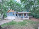 Beautiful two-story home with attached garage, front porch and mature landscaping, offering curb appeal and charm at 215 Little Brook Ln, Woodstock, GA 30188