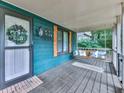 Inviting front porch featuring a swing, seasonal decorations and providing a cozy outdoor space to enjoy at 215 Little Brook Ln, Woodstock, GA 30188