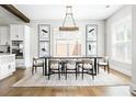 Bright dining room with modern chandelier, seating for six, neutral tones, and luxury vinyl plank flooring at 2792 Mathews Se St, Smyrna, GA 30080