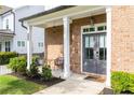 Inviting front porch features a brick facade, stylish double doors, and comfortable seating for relaxing outdoors at 2792 Mathews Se St, Smyrna, GA 30080