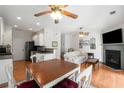 Bright open floor plan with kitchen, dining and living area featuring hardwood floors and fireplace at 3626 Lantern Crest Cv, Scottdale, GA 30079
