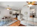 Open concept living area with hardwood floors, a ceiling fan, and a view into the kitchen at 3626 Lantern Crest Cv, Scottdale, GA 30079