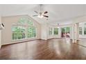 Open living room with hardwood floors, natural light, and sliding door access to a private balcony at 909 Wentworth Ct, Alpharetta, GA 30022