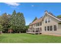Exterior shot showing an expansive, grassy backyard, wooden deck, and lush greenery at 1029 Ector Nw Dr, Kennesaw, GA 30152
