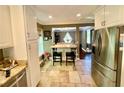 Well-lit kitchen featuring stainless steel refrigerator and a central island with barstool seating at 2694 Tritt Springs Ne Dr, Marietta, GA 30062