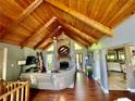 Spacious living room features vaulted wood ceiling, hardwood floors, and stone fireplace at 2694 Tritt Springs Ne Dr, Marietta, GA 30062