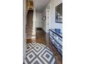 Inviting entryway with hardwood floors, geometric rug, staircase, and stylish console table at 312 Stonemont Dr, Atlanta, GA 30305