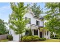 Beautiful two-story home featuring white siding, black shutters, and a well-manicured front yard at 3123 Cedar St, Scottdale, GA 30079