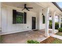 Inviting front porch with classic columns, dark accents, and stylish lighting at 3123 Cedar St, Scottdale, GA 30079