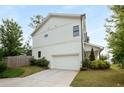 Spacious garage with a long driveway and well-maintained landscaping at 3123 Cedar St, Scottdale, GA 30079