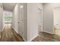 Hallway with wood floors connecting the living areas and featuring neutral wall paint at 423 Murphy Ave, Canton, GA 30114