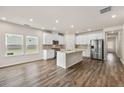 Spacious kitchen with white cabinets, stainless steel appliances, and central island open to the dining area at 423 Murphy Ave, Canton, GA 30114