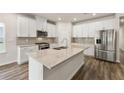 Modern kitchen with stainless steel appliances, granite countertops, a spacious island, and a gas range at 423 Murphy Ave, Canton, GA 30114