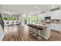 Bright, open-concept living room and kitchen area with hardwood floors and stainless steel appliances at 423 Murphy Ave, Canton, GA 30114