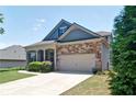 Attractive home with a stone and siding facade, attached garage, and a neatly maintained front yard at 514 Creekshire Cir, Canton, GA 30115