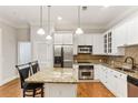 Modern kitchen with granite countertops, stainless steel appliances, and white cabinets at 11 Perimeter E Ctr # 1402, Dunwoody, GA 30346