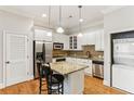 Well-lit kitchen featuring white cabinets, granite counters, and stainless steel appliances at 11 Perimeter E Ctr # 1402, Dunwoody, GA 30346