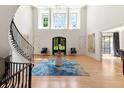 Grand two-story foyer featuring a curved staircase, high ceilings, and stylish decor with beautiful hardwood floors at 1191 W Conway Dr, Atlanta, GA 30327