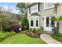 Landscaped front yard with a bay window and double front doors creates an inviting curb appeal at 1450 Crescent Walk, Decatur, GA 30033