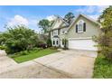 A view of the exterior with well manicured landscaping and a spacious driveway at 1450 Crescent Walk, Decatur, GA 30033