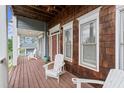 Inviting front porch with wooden flooring, white rocking chairs, and a charming, rustic design at 1797 Olive Se St, Atlanta, GA 30315
