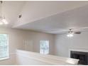 Spacious living area with vaulted ceilings, gas fireplace, and ceiling fan; bright natural light fills the room at 4162 Ward Lake Trl, Ellenwood, GA 30294
