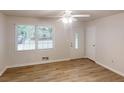 Open living room with a ceiling fan, a large window, and vinyl plank flooring at 5574 Oak Grove Dr, Acworth, GA 30102