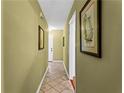 Inviting hallway with tile floors and neutral paint, enhanced by decorative wall art at 812 Manning Sw Way, Marietta, GA 30064