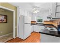 Efficient kitchen with white cabinets, modern appliances, and a ceiling fan at 812 Manning Sw Way, Marietta, GA 30064